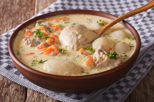 Creamy soup with chicken and vegetables close up in a bowl. horizontal

