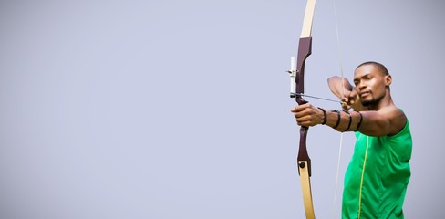 Composite image of front view of sportsman practising archery 