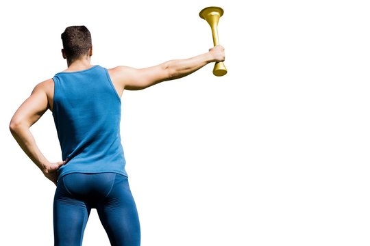Rear view of athletic man holding the Olympic torch