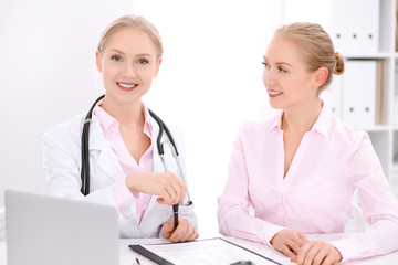 Doctor and  patient  sitting at the desk