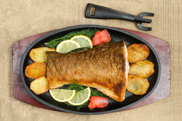 Fried fish lies in the pan.