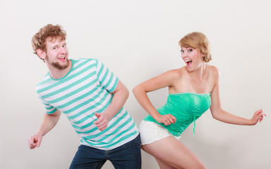 Playful young couple blonde girl bearded man