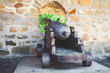 Antique cannon on gun carriage from loopholes fortress