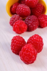 Fresh raspberries on white wooden table, healthy food