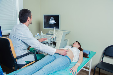  pregnant woman laying on the couch during ultrasound checking 