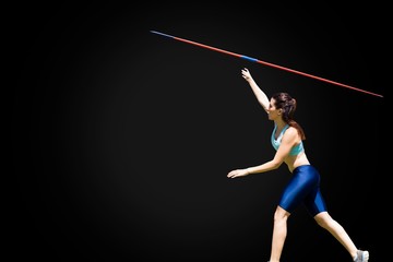 Profile view of sportswoman is practising javelin throw 