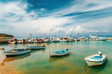 Fototapeta na wymiar Sunny view of boats, yachts from Nea Fokia village, Halkidiki, Greece.