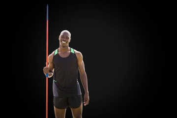 Front view of happy sportsman is holding a javelin 