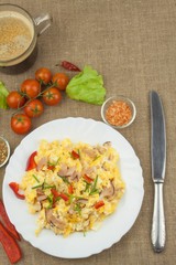 Homemade breakfast with a cup of coffee.Fresh scrambled eggs with bacon and vegetables. Breakfast athletes. Preparing eggs. Protein diet. Eggs in different kinds of preparations.
