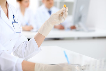 Scientific research team with clear solution in laboratory