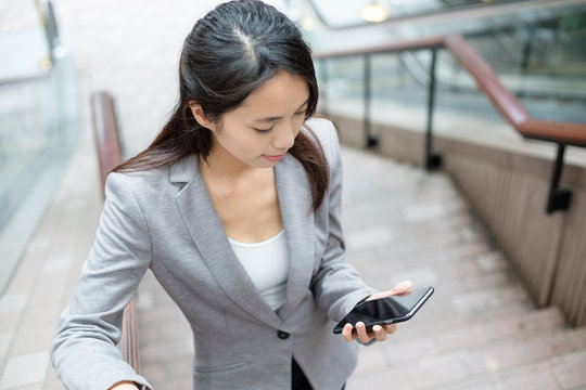 Business Woamn Use Of Cellphone And Going Up The Staircase