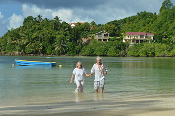 elderly couple rest at tropical resort