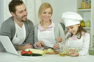 Obraz na płótnie Canvas happy family cooking in kitchen