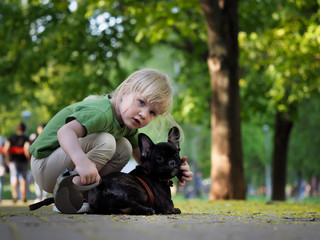 The child with a dog in the park for a walk