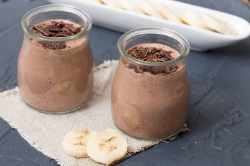 Chocolate pudding with chia seed, bananas and nuts,  in a glass
