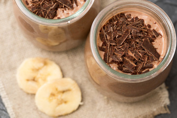 Chocolate pudding with chia seed, bananas and nuts,  in a glass
