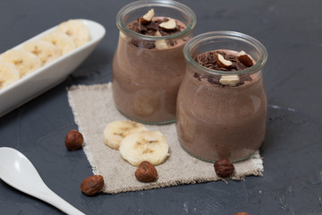 Chocolate pudding with chia seed, bananas and nuts,  in a glass