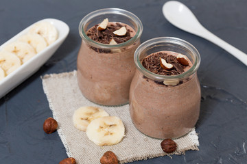 Chocolate pudding with chia seed, bananas and nuts,  in a glass