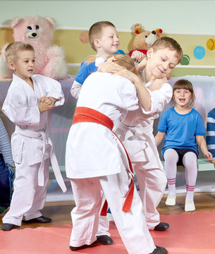 Children learn in training judo sparring