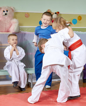 Girl and boy are trained judo sparring