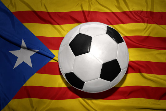 black and white football ball on the national flag of catalonia