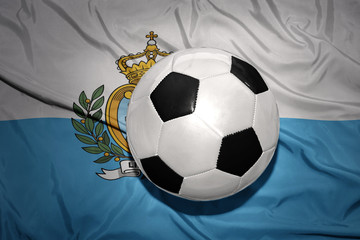 Fototapeta premium black and white football ball on the national flag of san marino