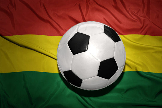 black and white football ball on the national flag of bolivia