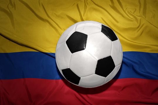 black and white football ball on the national flag of colombia
