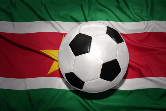 black and white football ball on the national flag of suriname