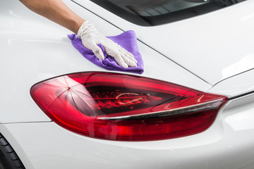 Car detailing series : Closeup of hand cleaning white car