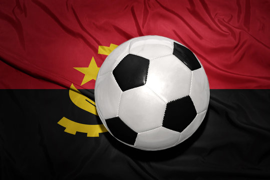 black and white football ball on the national flag of angola