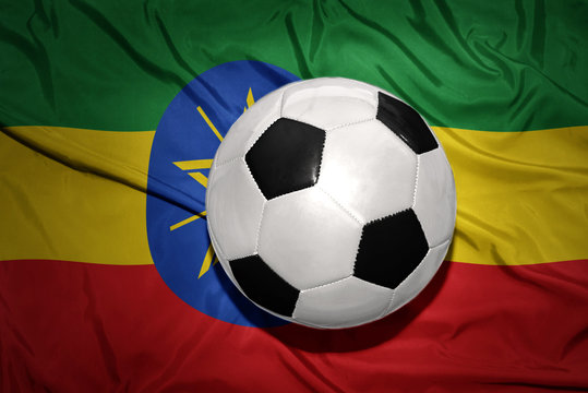 black and white football ball on the national flag of ethiopia