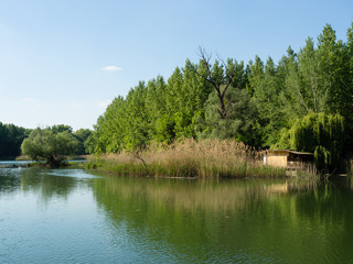 Quiet bank of the Danube river in spring with houseboat