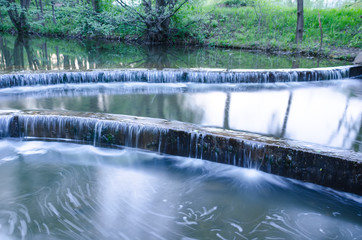small waterfall on a small picturesque brook in the forest
