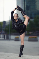 Beautiful woman performing acrobatics in the city