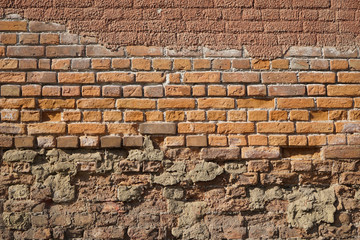 Old wall with different brick structures.