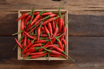 Red Hot Chili Peppers in wooden box on old wooden background, 