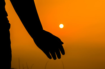 hands backlit by a bright evening sun in a closeup