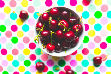 group of cherries on colorful polka dot trend background, pop theme