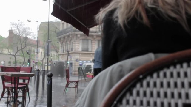 Raining In Paris While Waiting In Restaurant. Sitting on the terrace of a restaurant watching the rain in Paris, France