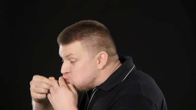Man eating a cheeseburger. Black