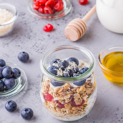 Healthy breakfast - glass jars of oat flakes with  fruit, yogurt.