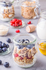 Healthy breakfast - glass jars of oat flakes with  fruit, yogurt.