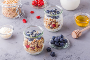 Healthy breakfast - glass jars of oat flakes with  fruit, yogurt.