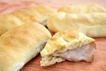 slice of white pizza stuffed with mortadella