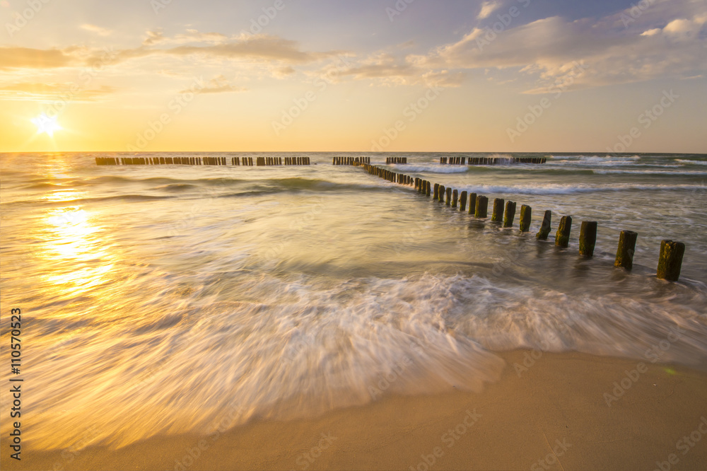 Wall mural sunset over the sea beach