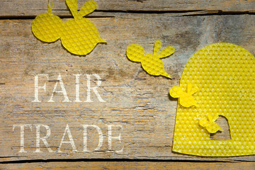 beeswax, bees and a beehive on wooden table, fair trade