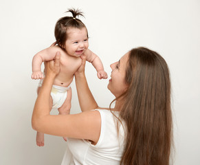 mother lift up baby, play and having fun