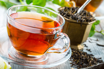 Tea. Mint Tea. Herbal tea. Mint leaf. Mint leaves. Tea in a glass cup, mint leaves, dried tea, sliced lime. herbs tea and mint leaves on a slate plate in a restaurant or teahouse tea room.
