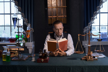 Scientists are studying science in vintage office with solutions and reagents